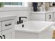 Close up of a soaking tub with a matte black faucet and quartz countertops at 6790 S Springs Pl, Chandler, AZ 85249