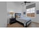 A cozy bedroom with neutral tones, stylish bedding, and a dark wood nightstand at 6790 S Springs Pl, Chandler, AZ 85249