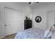 Bedroom featuring a modern closet, sleek black dresser, and a decorative round mirror at 6790 S Springs Pl, Chandler, AZ 85249