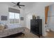 Well-lit bedroom with a ceiling fan, large window and a walk-in closet at 6790 S Springs Pl, Chandler, AZ 85249