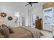 Bedroom featuring an ensuite bathroom, exterior door, and rustic wood dresser at 6790 S Springs Pl, Chandler, AZ 85249