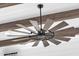 Unique ceiling fan with wooden blades adds rustic charm to this home's interior design at 6790 S Springs Pl, Chandler, AZ 85249