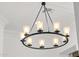 Close-up of a round, black chandelier with nine lights against a white, shiplap ceiling at 6790 S Springs Pl, Chandler, AZ 85249