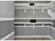 Walk in closet with adjustable shelving and grey walls with white stripes at 6790 S Springs Pl, Chandler, AZ 85249