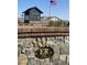 Close-up of the stone monument at community entrance with a vintage-style community sign and American flag at 6790 S Springs Pl, Chandler, AZ 85249