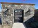 Stone wall and iron gate with a traditional design, featuring two lanterns and decorative stonework at 6790 S Springs Pl, Chandler, AZ 85249