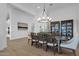 Elegant dining room features a wood table, stylish chandelier, and beautiful built-in cabinets at 6790 S Springs Pl, Chandler, AZ 85249