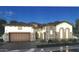Stunning home with stone accents, tile roof, arched entryway, and well-manicured landscaping at 6790 S Springs Pl, Chandler, AZ 85249