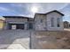 Stunning stone and stucco exterior featuring a spacious garage and inviting entryway at 6790 S Springs Pl, Chandler, AZ 85249