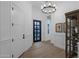 Bright foyer featuring a chandelier, high ceilings, decorative moulding, and wood look tile at 6790 S Springs Pl, Chandler, AZ 85249