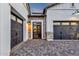 View of the brick-paved entrance way of a house with two garage doors at 6790 S Springs Pl, Chandler, AZ 85249