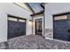 View of the brick-paved entrance way of a house with two garage doors at 6790 S Springs Pl, Chandler, AZ 85249