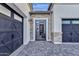 Front exterior with a gated courtyard entrance, pavers, and garages on either side at 6790 S Springs Pl, Chandler, AZ 85249