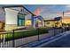 Attractive exterior showcasing the charming architecture, manicured lawn, and wrought iron fence at 6790 S Springs Pl, Chandler, AZ 85249