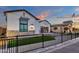 Single-Gathering home featuring a manicured front lawn, custom brickwork, and a wrought iron fence at 6790 S Springs Pl, Chandler, AZ 85249