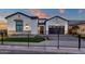 Charming single-Gathering home with a well-manicured lawn, custom driveway, and secure wrought iron fence at 6790 S Springs Pl, Chandler, AZ 85249