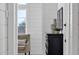 Bright hallway with shiplap walls and a view to a cozy seating area and backyard at 6790 S Springs Pl, Chandler, AZ 85249