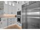 Bright kitchen boasts white cabinets, stainless steel Sub-Zero refrigerator, built in oven and microwave at 6790 S Springs Pl, Chandler, AZ 85249