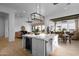 Open concept with kitchen, dining, and living spaces featuring modern appliances and stylish accents at 6790 S Springs Pl, Chandler, AZ 85249