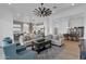 Bright living room with cozy seating, decorative ceiling fan, and seamless access to the kitchen and dining areas at 6790 S Springs Pl, Chandler, AZ 85249