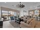 Spacious living room with large windows, comfortable seating, and an open view of the backyard at 6790 S Springs Pl, Chandler, AZ 85249