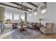 Bright living room featuring a comfortable sectional, large windows, ceiling fan, and stylish decor at 6790 S Springs Pl, Chandler, AZ 85249