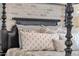 Close-up of the comfortable four-poster bed featuring decorative pillows and a patterned comforter at 6790 S Springs Pl, Chandler, AZ 85249