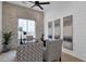 Bright office with brick accent wall, shiplap walls, and elegant furnishings under a ceiling fan at 6790 S Springs Pl, Chandler, AZ 85249