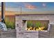 Cozy outdoor fireplace with detailed stonework and seating arrangement, creating an inviting atmosphere for gatherings at 6790 S Springs Pl, Chandler, AZ 85249