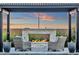 Outdoor entertainment area featuring a stylish fireplace and comfortable seating, perfect for relaxation and socializing at 6790 S Springs Pl, Chandler, AZ 85249