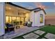 Relaxing patio features comfortable seating, ceiling fan, and view through sliding glass doors at 6790 S Springs Pl, Chandler, AZ 85249
