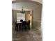 Charming dining room with tile flooring, decorative chandelier, and large windows that fills the room with light at 7163 W Lamar Rd, Glendale, AZ 85303