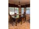 Traditional dining room with dark wood table, ornate chairs, and natural light from large windows at 7163 W Lamar Rd, Glendale, AZ 85303