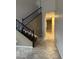 Hallway with tile flooring, staircase with dark wood banister and neutral paint that leads to a upper level at 7163 W Lamar Rd, Glendale, AZ 85303