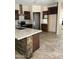 Modern kitchen features dark cabinets, stainless steel appliances, stone accents, and a large island at 7163 W Lamar Rd, Glendale, AZ 85303
