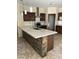Modern kitchen features dark cabinets, stainless steel appliances, stone accents, and a large island at 7163 W Lamar Rd, Glendale, AZ 85303