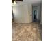 Open living room with neutral paint, tile floors, and view to hallway and bedrooms at 7163 W Lamar Rd, Glendale, AZ 85303