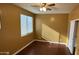 Bedroom featuring hardwood floors, ceiling fan and natural light from window at 7511 S 45Th Dr, Laveen, AZ 85339
