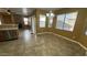 A dining area features tile floors, a chandelier, and large windows at 7511 S 45Th Dr, Laveen, AZ 85339