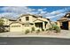 Two-story home with a three-car garage and desert landscaping for a low-maintenance, water-wise front yard at 7511 S 45Th Dr, Laveen, AZ 85339