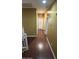 Upstairs hallway with wood flooring, multiple doors, and neutral paint, connecting various rooms at 7511 S 45Th Dr, Laveen, AZ 85339