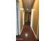 A long hallway with wood floors and doors leading to different rooms at 7511 S 45Th Dr, Laveen, AZ 85339