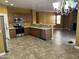 A spacious kitchen features wooden cabinets, stainless steel appliances, and a view to the living room at 7511 S 45Th Dr, Laveen, AZ 85339