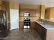 A spacious kitchen features wooden cabinets, stainless steel appliances, and light countertops at 7511 S 45Th Dr, Laveen, AZ 85339