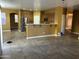 Open-concept kitchen seamlessly connects to the living area, featuring modern appliances and a breakfast bar at 7511 S 45Th Dr, Laveen, AZ 85339