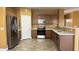 A spacious kitchen features wooden cabinets, stainless steel appliances, and light countertops at 7511 S 45Th Dr, Laveen, AZ 85339