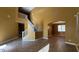 Spacious living room featuring high ceilings, tile flooring, and an open staircase, creating a bright and airy atmosphere at 7511 S 45Th Dr, Laveen, AZ 85339