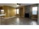 A living room features tile floors, a stone fireplace, and large windows at 7511 S 45Th Dr, Laveen, AZ 85339