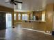 Open living space with tile flooring, a breakfast bar, and sliding glass doors to the patio, blending indoor-outdoor living at 7511 S 45Th Dr, Laveen, AZ 85339