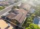Aerial view of a home with a tile roof, patio, pool, and green landscaping at 76 W Stacey Ln, Tempe, AZ 85284